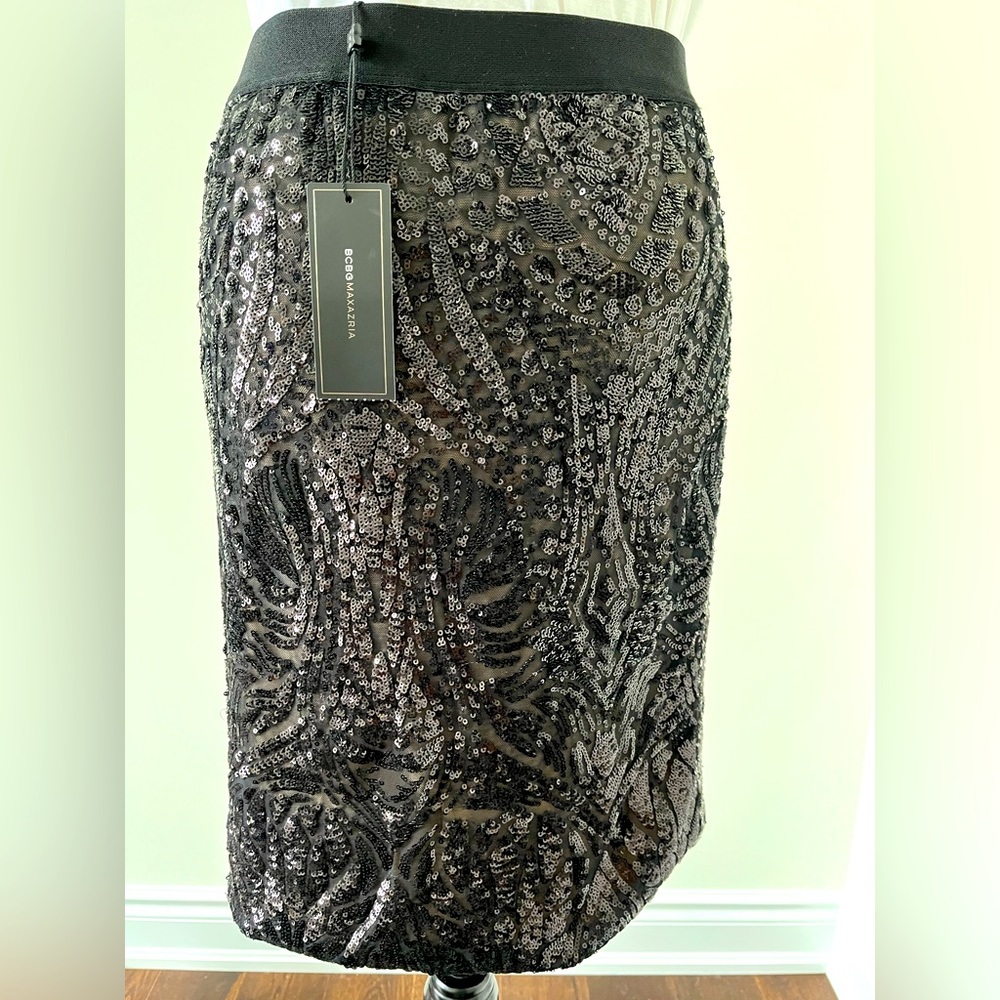 New with tag. BCBG black sequins skirt. mid thigh.